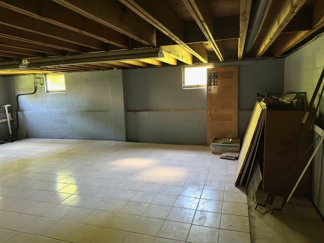 Attic Basement Cleanout crew removing boxes furniture and stored items from a basement