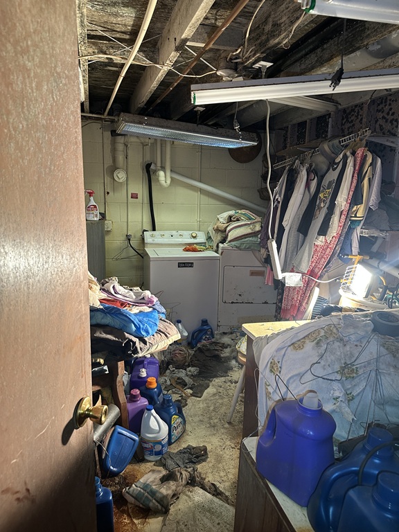 Washer Dryer Appliances in cluttered room